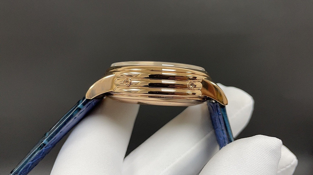 Patek Philippe watch with blue leather strap and gold-tone case, side profile.