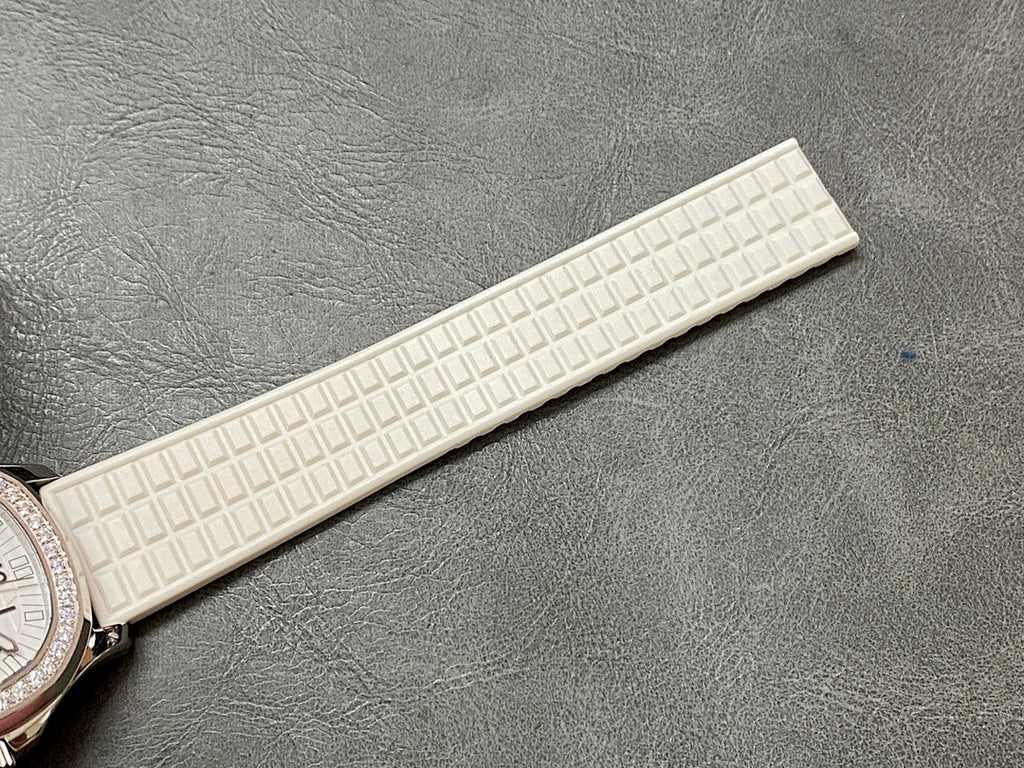 Textured white rubber watch strap with raised grid pattern, end portion visible