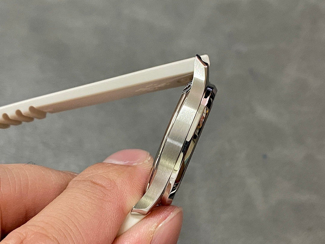Watch case profile with crown and textured white rubber strap, side angle