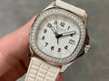Diamond bezel luxury wristwatch with white dial and textured white strap, rose gold case