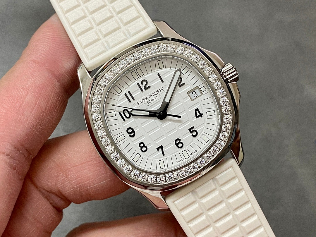 Diamond bezel wristwatch with white dial, rose gold tone case, textured white strap