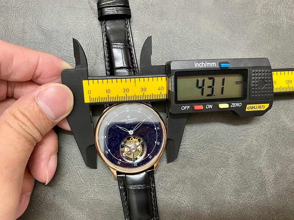 Patek Philippe wristwatch on calipers, black leather strap and starry blue dial