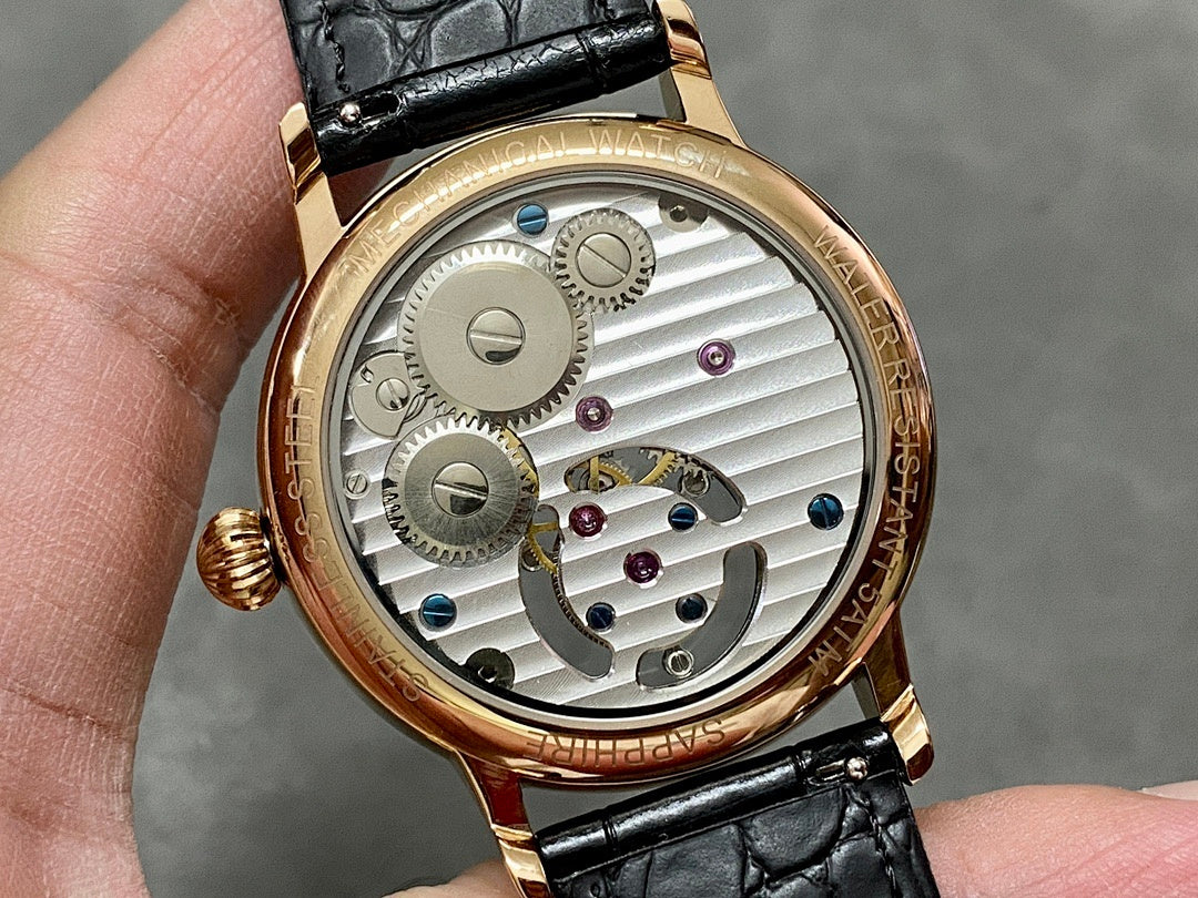 Patek Philippe wristwatch caseback with exposed gears and silver dial, black leather strap