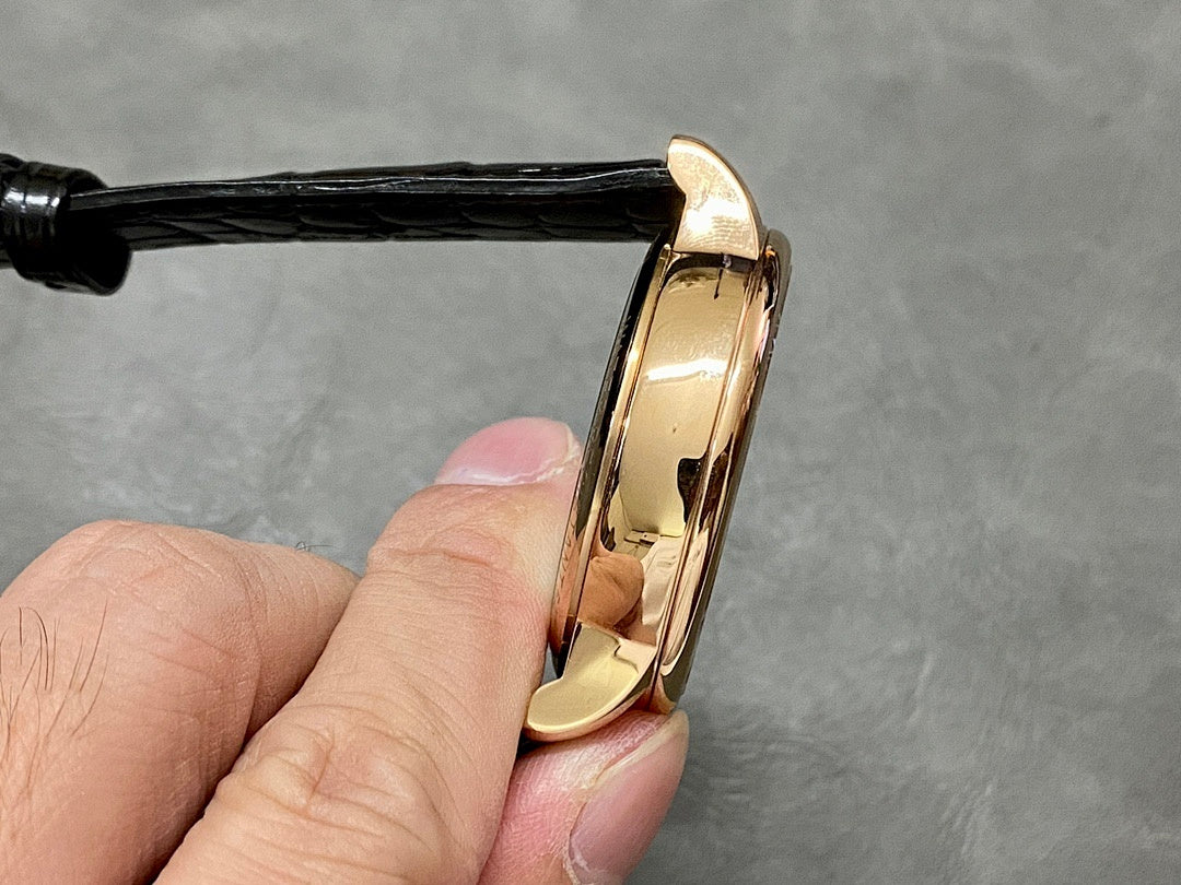 Patek Philippe wristwatch case edge, rose-gold tone and black leather strap