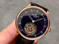Patek Philippe wristwatch with navy starry dial, open gear display, black leather strap