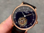 Patek Philippe wristwatch with navy starry dial, open gear display, black leather strap
