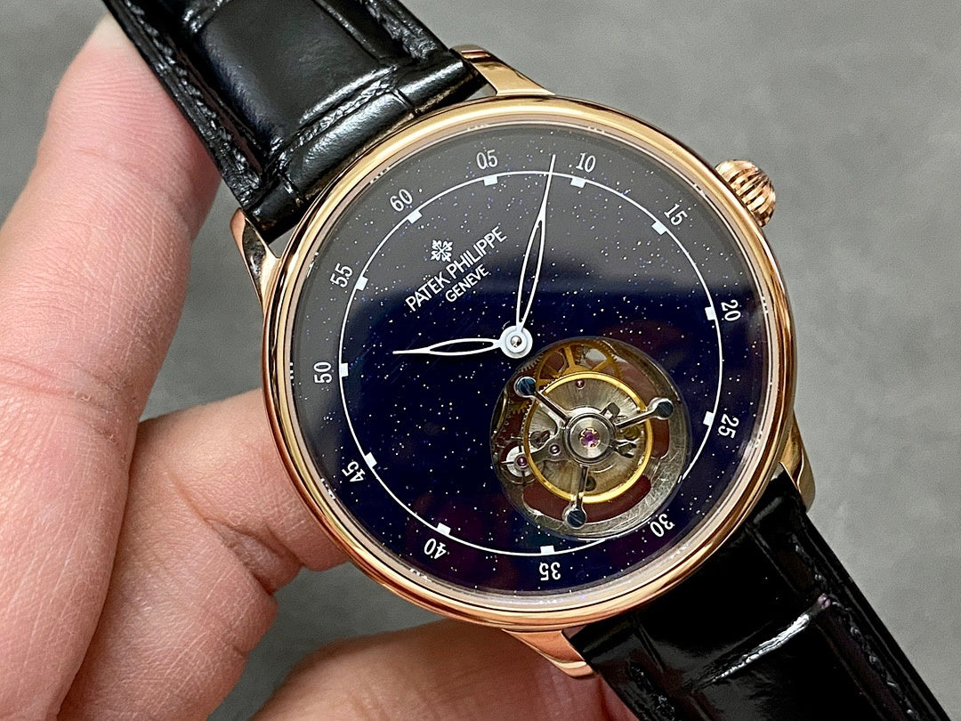 Patek Philippe wristwatch close-up, navy dial with open movement, black leather strap