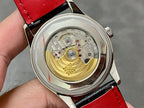 Stainless watch case with open back showing gold-toned mechanical movement