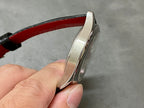 Stainless watch case side profile with red leather strap