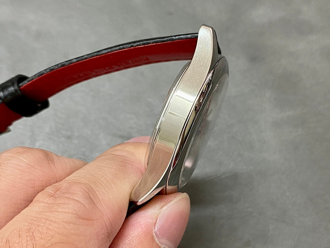 Stainless watch case side profile with red leather strap
