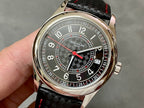 Round stainless watch with dark dial, red accents, and black patterned leather strap