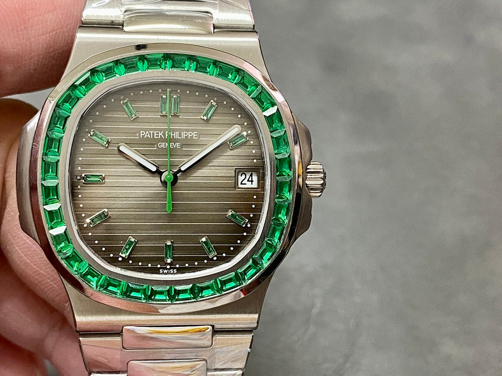 Patek Philippe wristwatch with green jeweled bezel, silver case, gray dial, date window 24