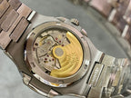 Patek Philippe watch caseback with exposed gold-toned movement and metal bezel