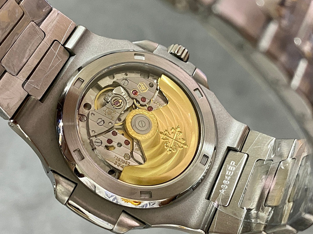 Patek Philippe watch caseback with exposed gold-toned movement and metal bezel
