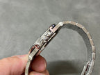 Patek Philippe watch with silver bracelet, crown side detail, and polished case