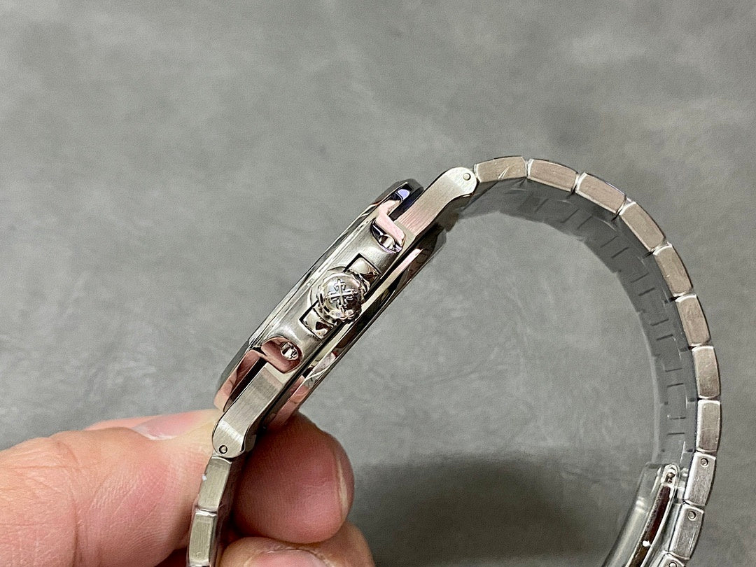 Patek Philippe watch with silver bracelet, crown side detail, and polished case