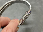Patek Philippe watch with silver bracelet and side case with crown guards