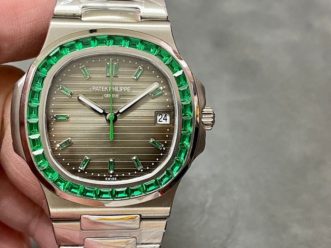 Patek Philippe watch front view with green bezel, gray dial, silver bracelet, date window 24