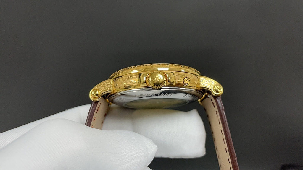 Patek Philippe watch back view, gold-tone case and brown leather strap.