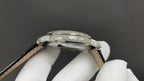 Patek Philippe watch side profile with silver case and brown leather strap