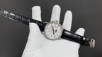 Patek Philippe wristwatch full view, white dial with multiple subdials, black leather strap