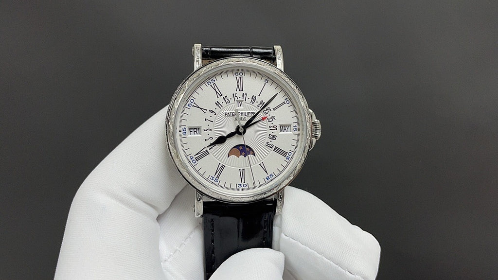 Patek Philippe wristwatch with white dial and Roman numerals, black leather strap