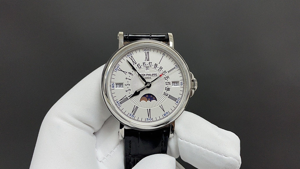 Patek Philippe watch with white dial, silver case, black leather strap and subdials