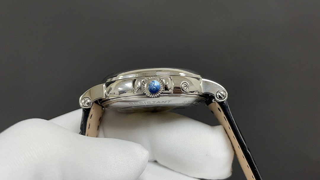 Patek Philippe watch crown-side view with blue detail and polished silver case