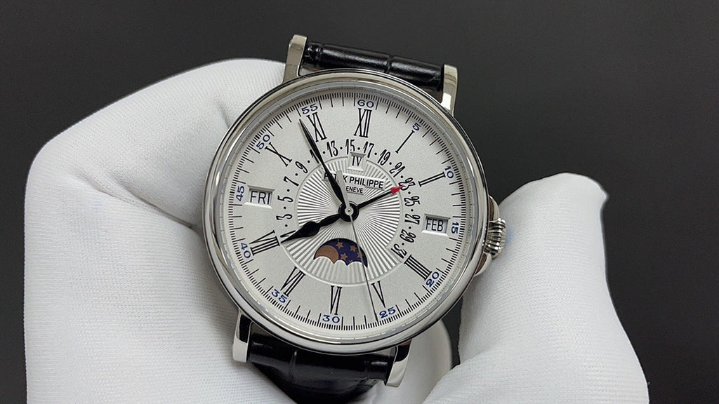 Patek Philippe watch with white dial, silver bezel, black leather strap and moonphase