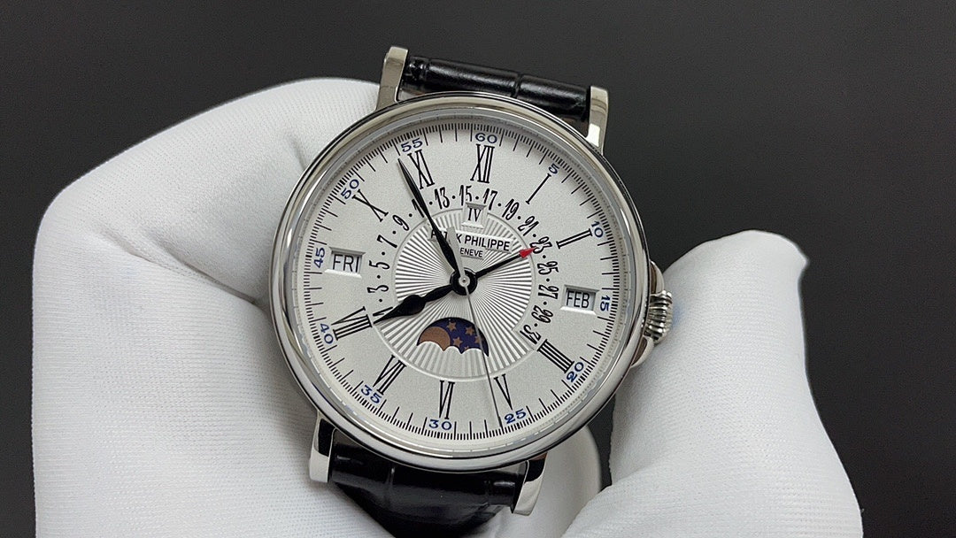 Patek Philippe watch with white dial, silver bezel, black leather strap and moonphase