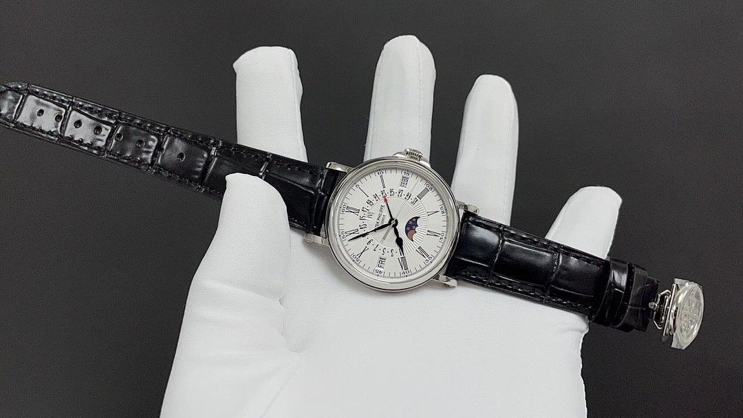 Patek Philippe watch on black leather strap across white gloves, silver clasp visible