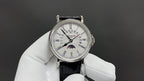 Patek Philippe watch front view, white dial with subdials and black strap