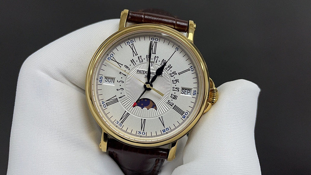 Patek Philippe wristwatch with gold-tone case, white dial with subdials, brown leather strap