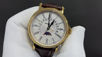 Patek Philippe wristwatch with gold-tone case, white dial with subdials, brown leather strap