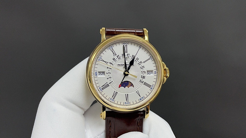 Patek Philippe wristwatch with gold-tone case, white dial, brown leather strap and moon phase