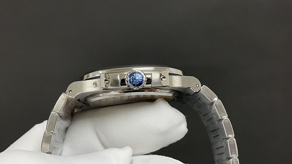 Steel wristwatch case back with blue center medallion and metal bracelet links