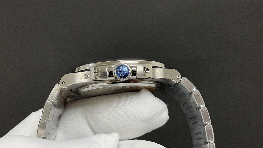 Steel wristwatch case back with blue center medallion and metal bracelet links
