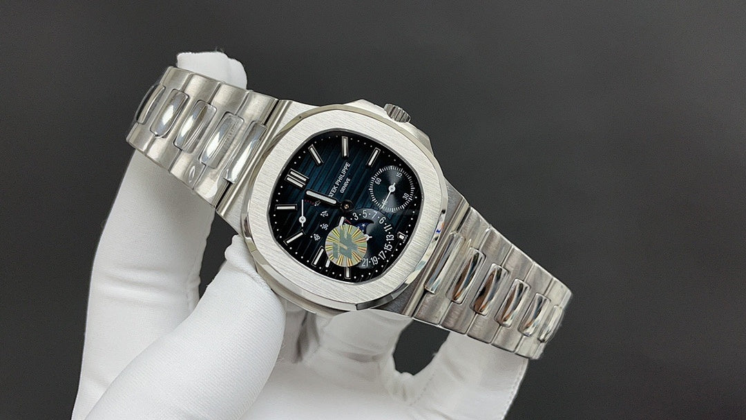 Wristwatch in silver tone with black dial and crown detail, on metal bracelet