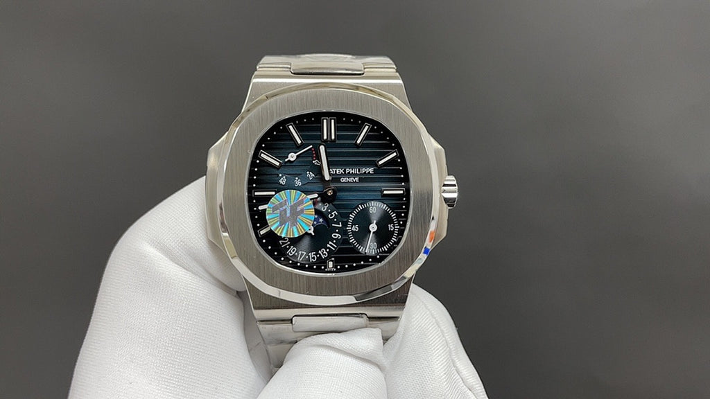 Front view of silver wristwatch with black dial and multi-subdial design on bracelet