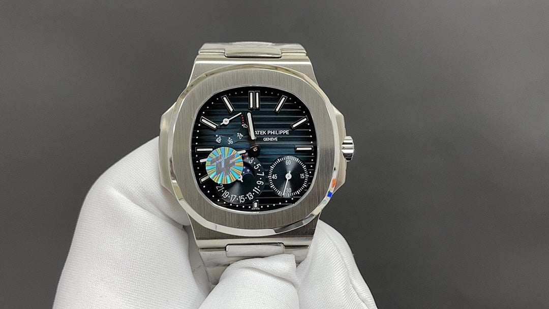 Front view of silver wristwatch with black dial and multi-subdial design on bracelet