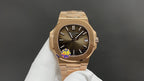 Gold-tone wristwatch with black dial, Roman numerals, and linked metal bracelet