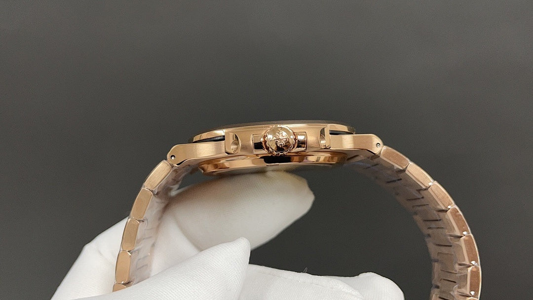 Gold-tone wristwatch case back with visible crown and polished links