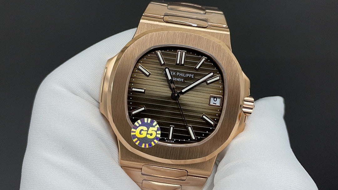 Gold-tone wristwatch with black dial and Roman numerals on a metal bracelet