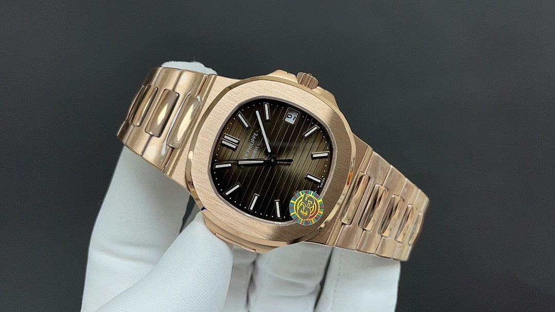 Gold-tone wristwatch angled view showing crown, bezel, and linked bracelet