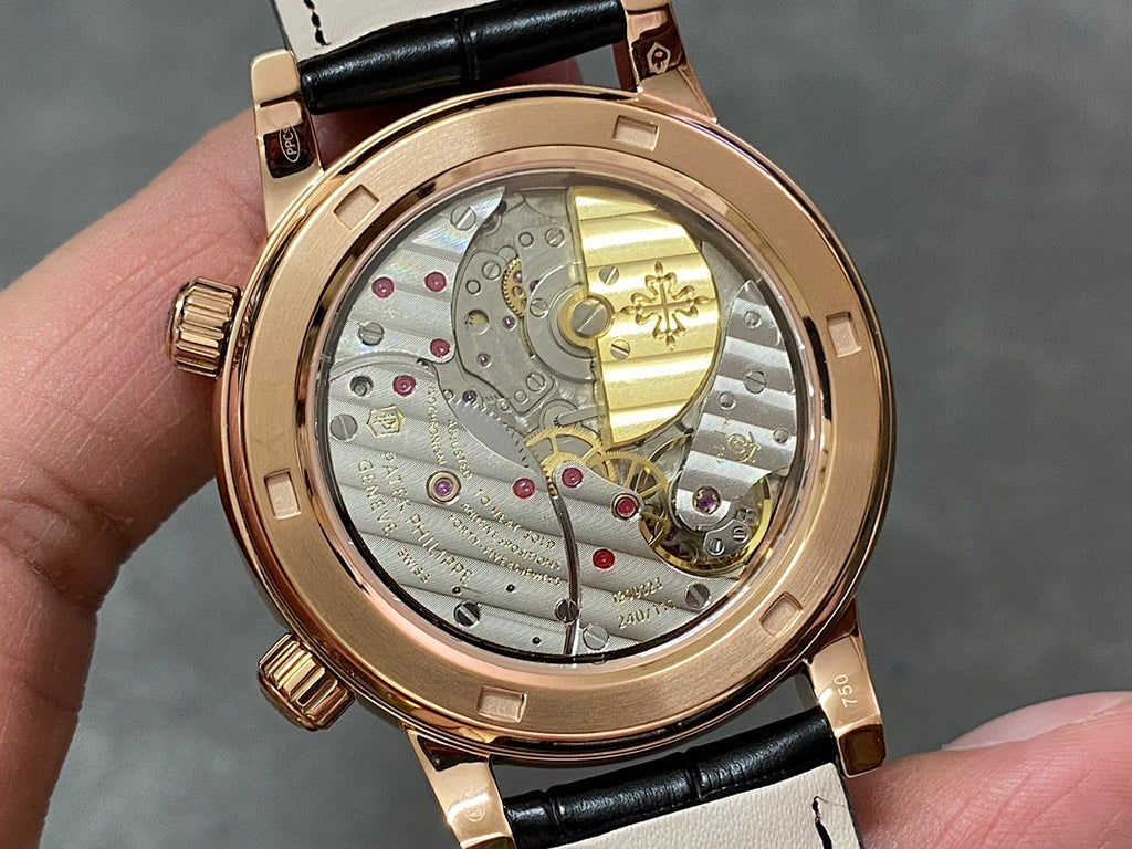 Luxury wristwatch with openwork dial showing gold-toned gears on black leather strap
