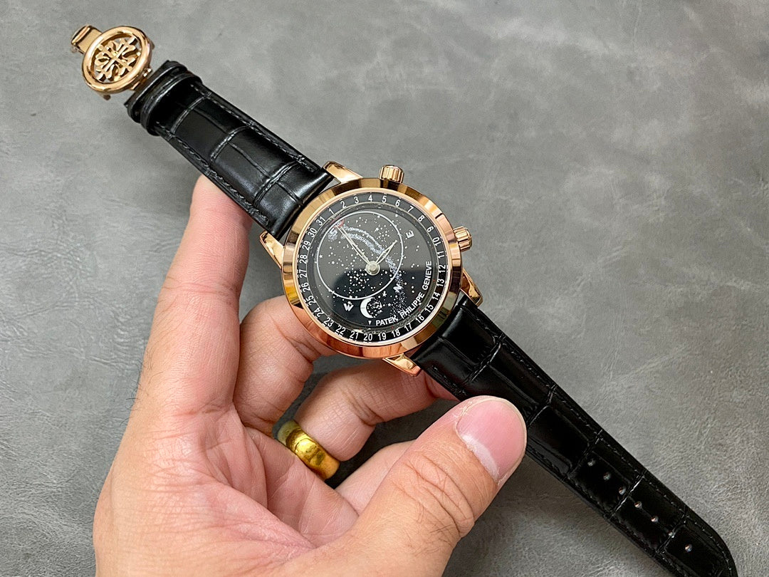 Luxury wristwatch on black leather strap with starry dark dial and rose-gold bezel