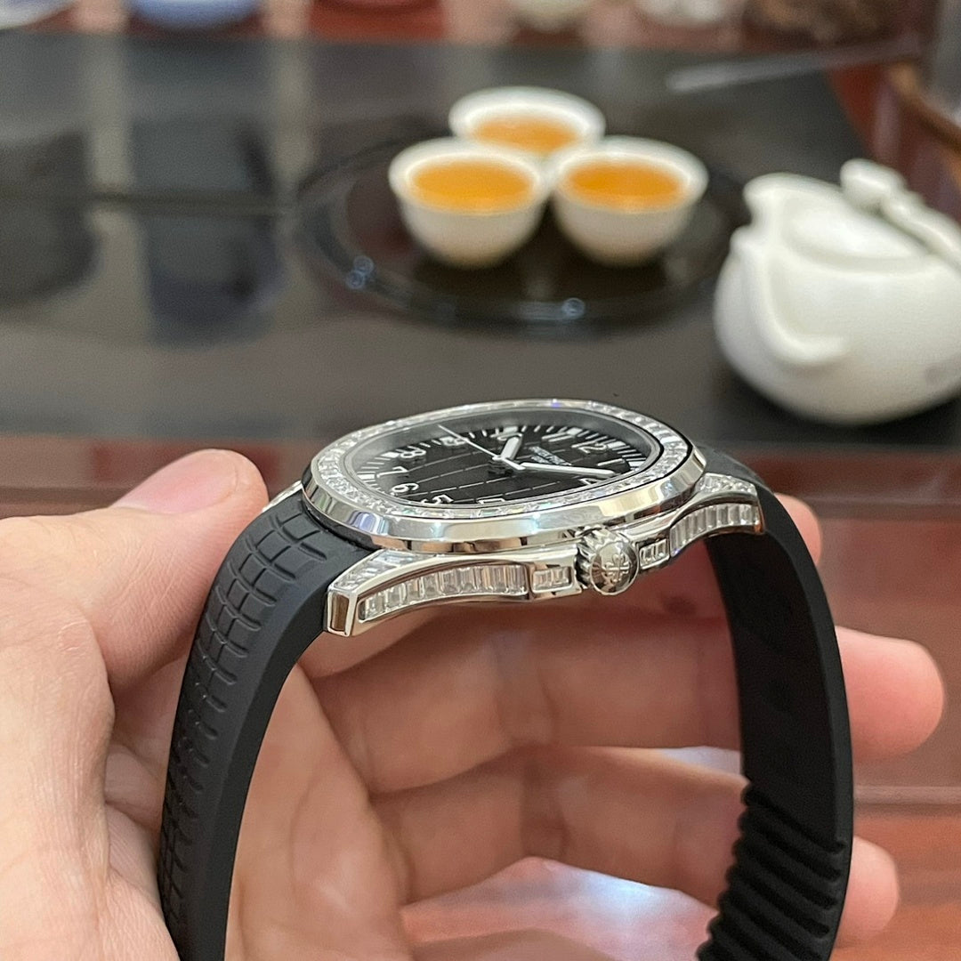 Patek Philippe watch on black rubber strap with jeweled bezel, side profile close-up