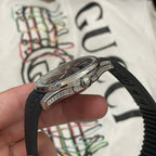 Patek Philippe wristwatch with black rubber strap and jeweled bezel, crown side view