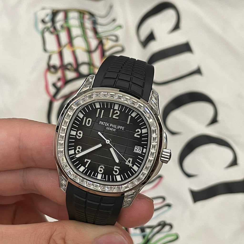 Patek Philippe wristwatch front view with black dial, black rubber strap and diamond bezel