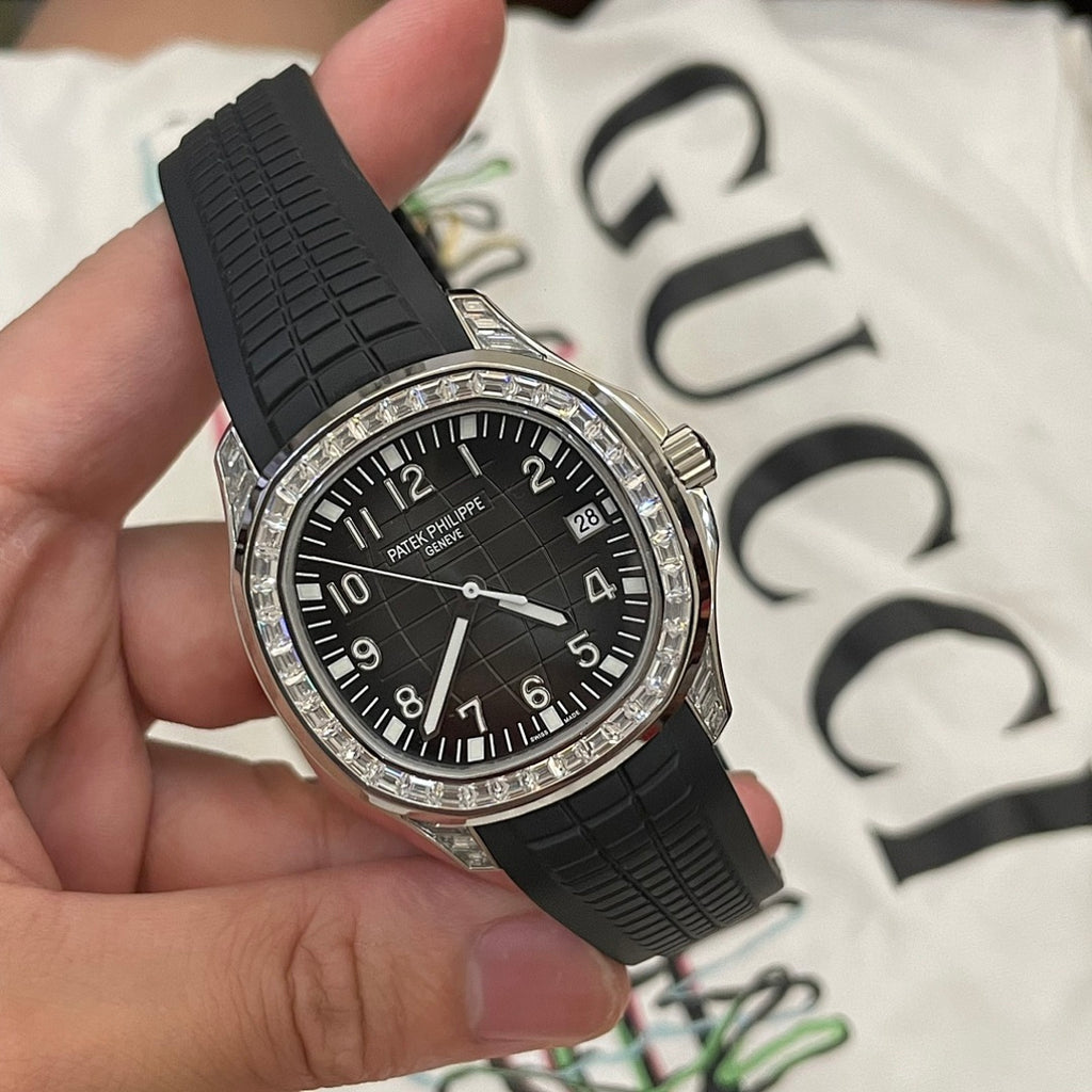 Patek Philippe luxury wristwatch with black dial, black rubber strap, silver diamond bezel